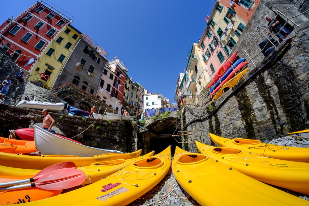 Yellow kayaks in front of colorful houses in the Cinque Terre