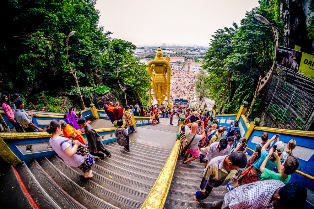 Visitors climbing the painted stairs at the Batu Caves, Malaysia